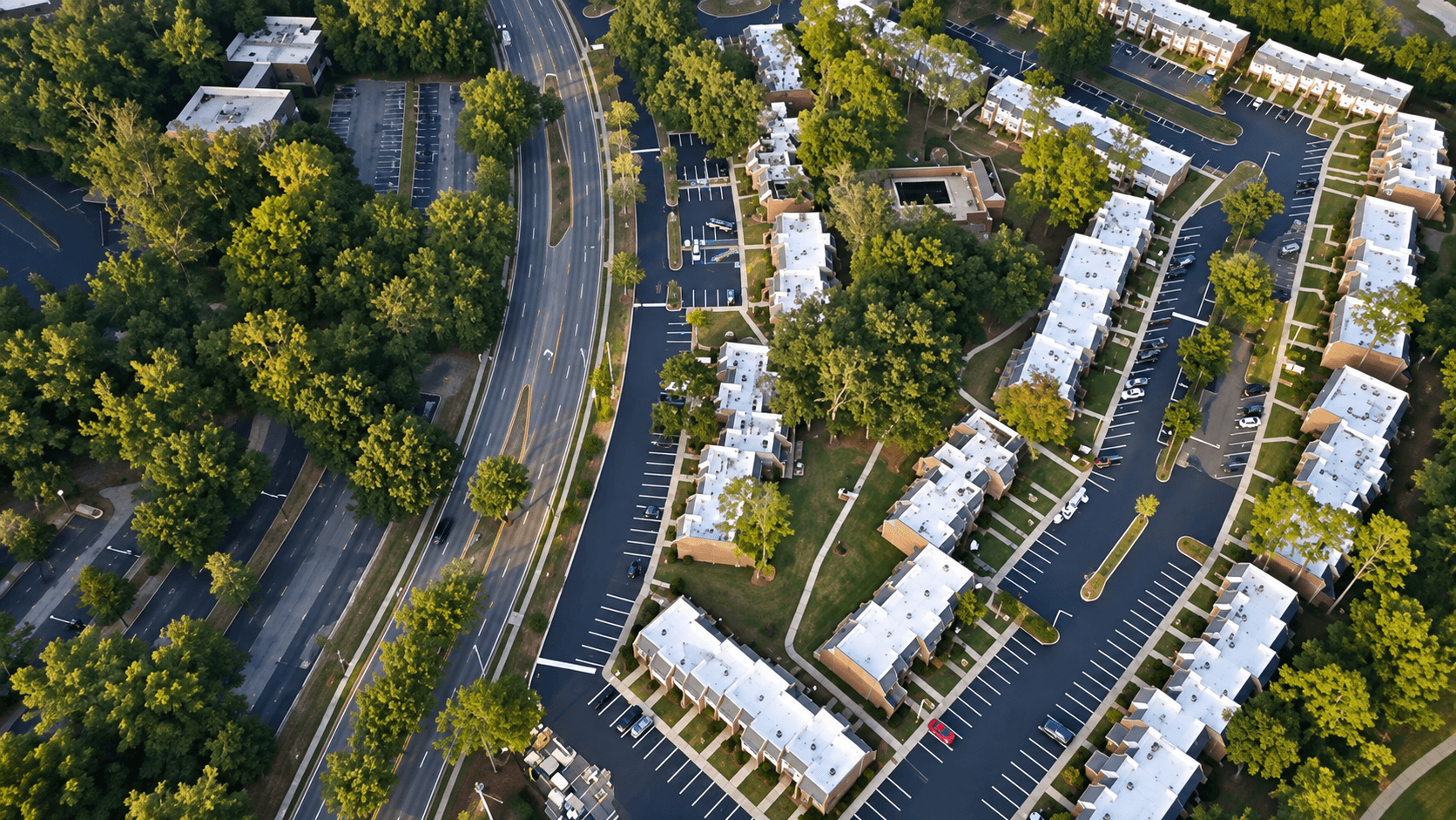 Aerial view of a paved parking lot at a multi-family apartment complex in Tallahassee, FL