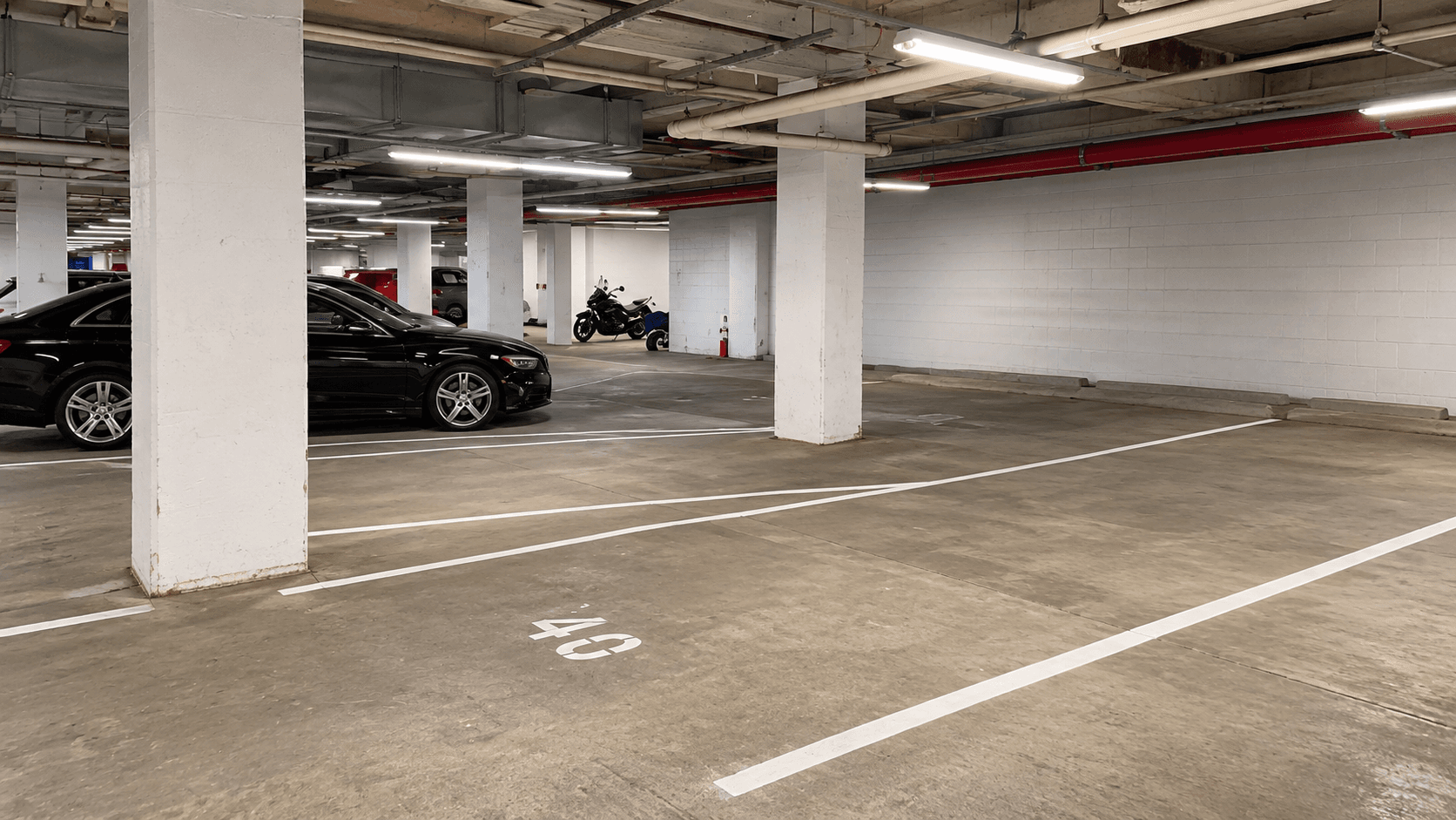 Multi-level parking garage with fresh white stall striping and ADA-compliant markings in the Bronx, NY