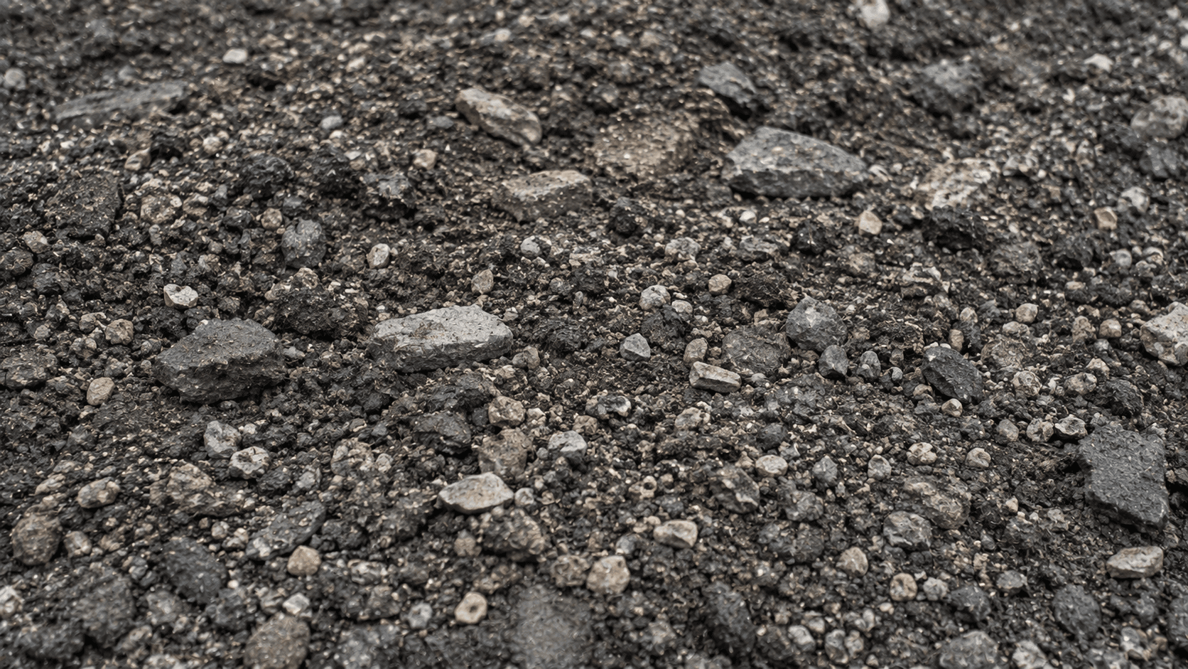Close-up of pulverized asphalt and base material during full-depth reclamation