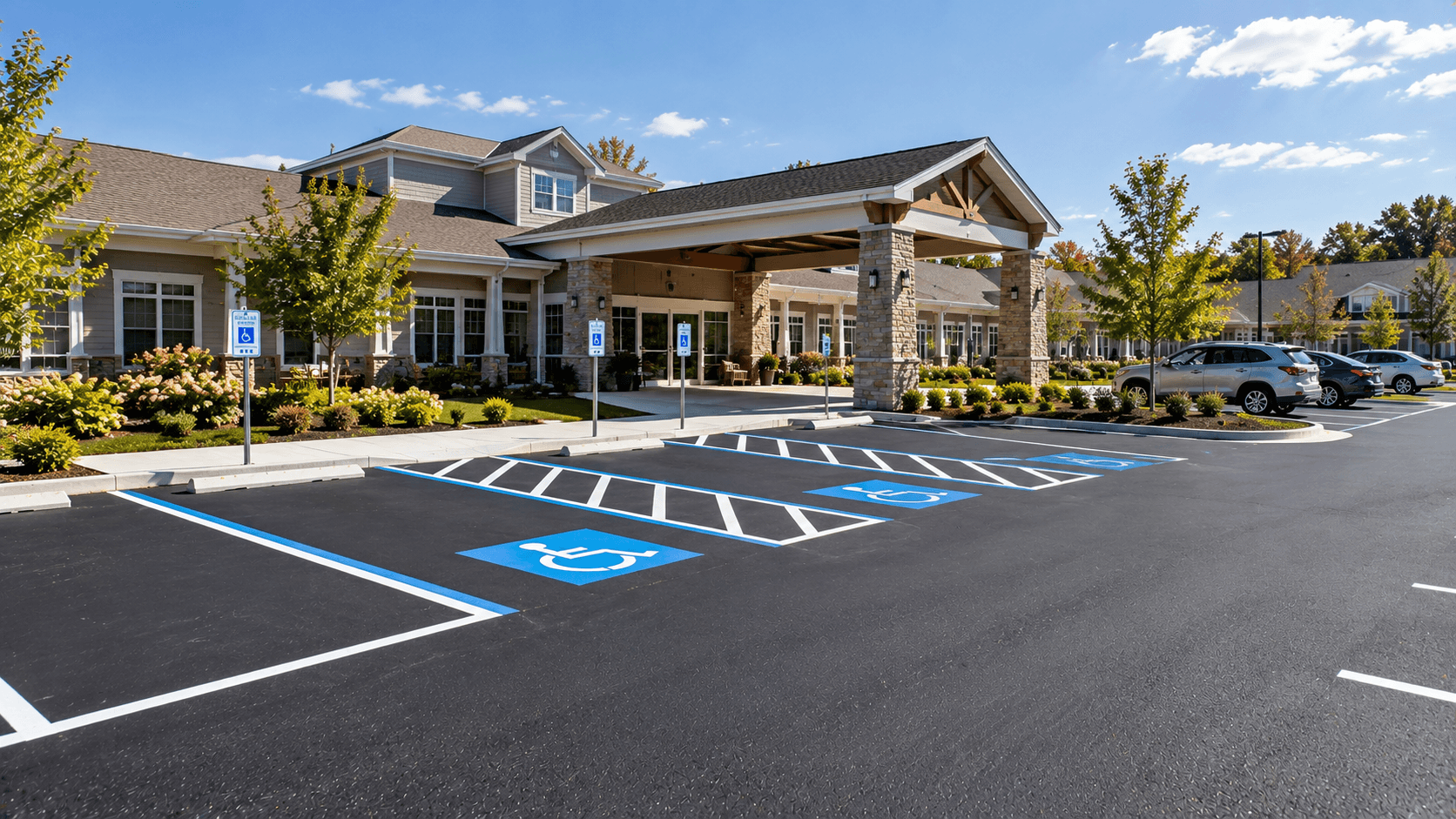 Freshly paved senior living facility parking lot with clear accessible stalls near the entrance