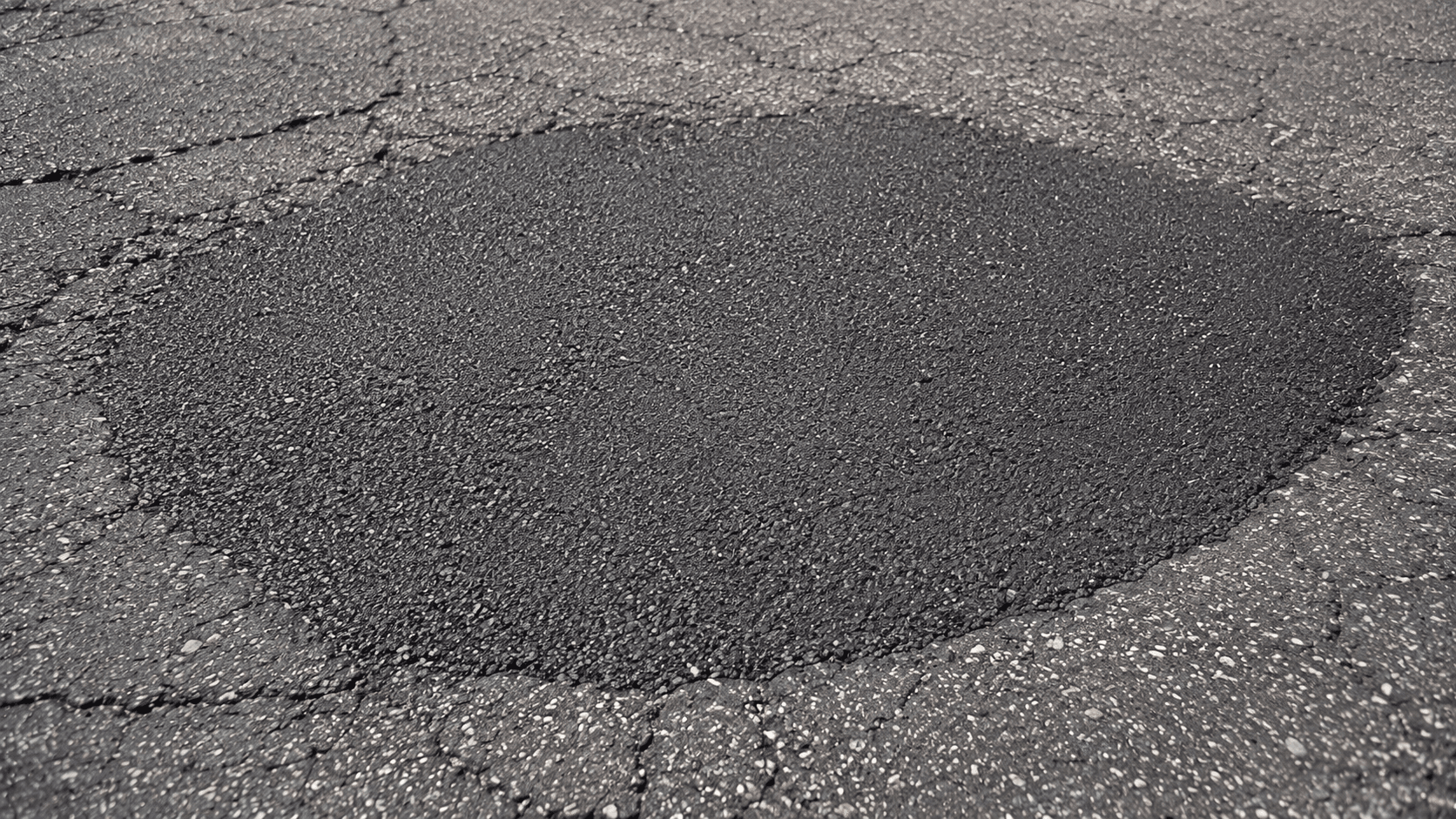 Seamless infrared asphalt patch blended into a commercial parking lot surface