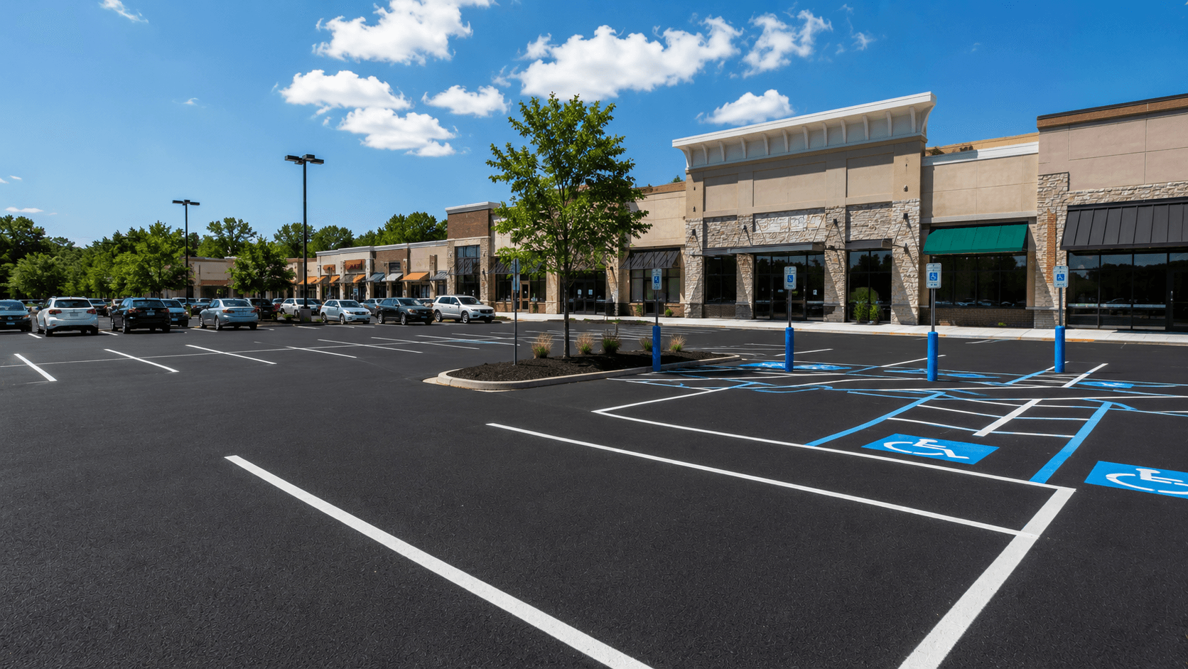 Freshly paved and striped shopping center parking lot with storefronts in the background